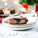Slice of salted caramel mocha cheesecake with fudge drizzle on a plate