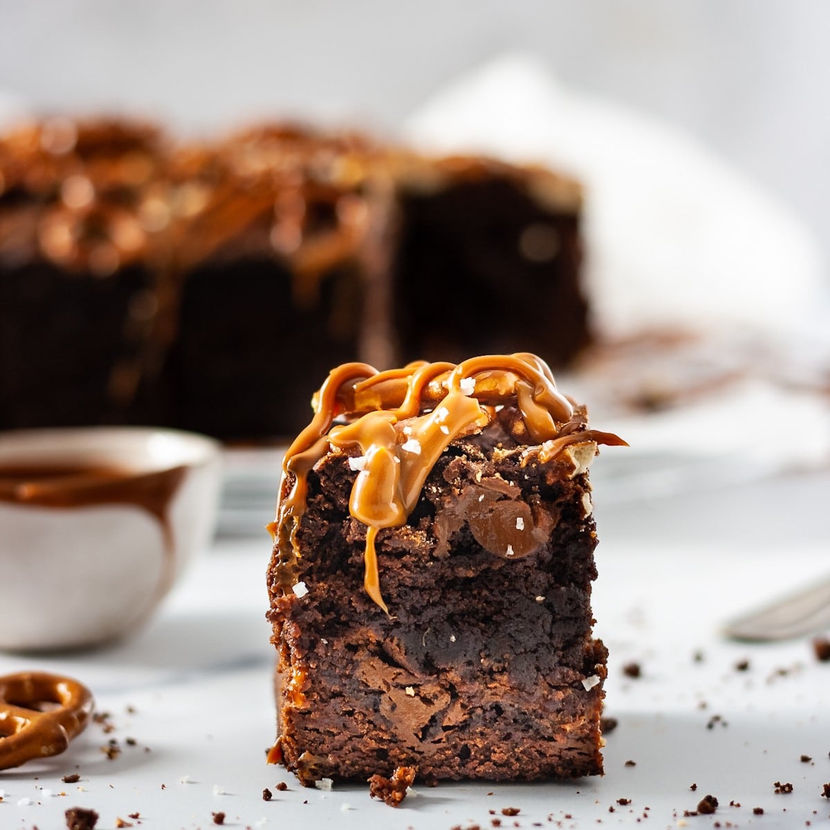 piece of chocolate brownies with dulce de leche drizzle down the side