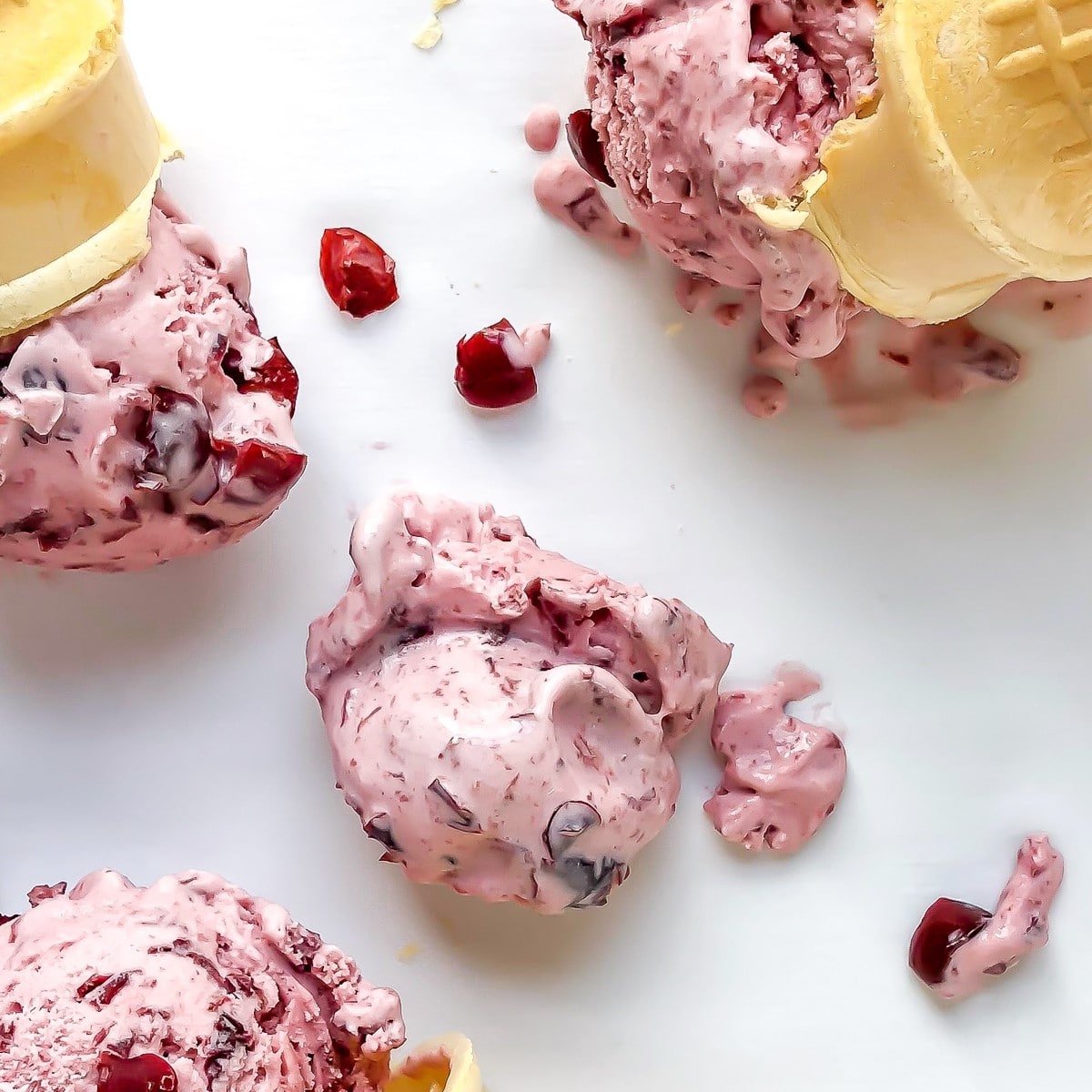 scoops of homemade sour cherry ice cream recipe with ice cream cones