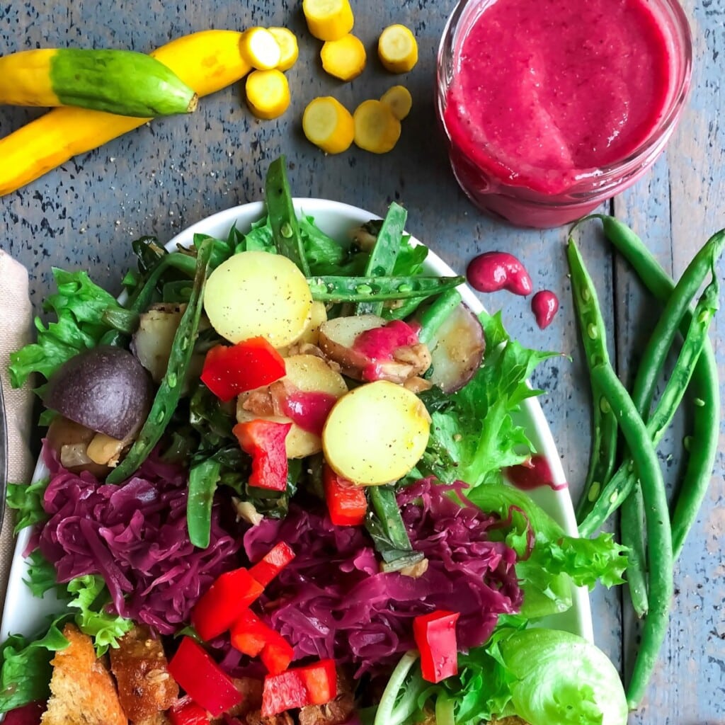 Bright and vibrant farmer's market salad recipe with a beet vinaigrette.