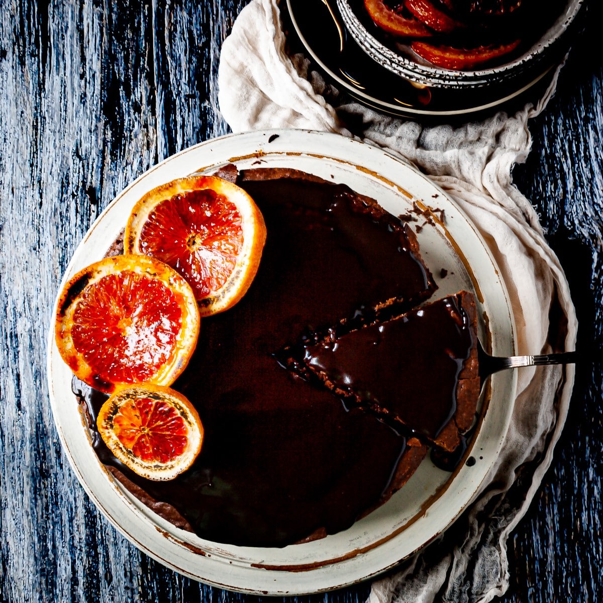 Overhead view of a boozy blood orange chocolate cake with chocolate ganache.