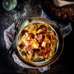 Braised beef shank ragu and pappardelle on a plate with a fork.