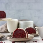 Slice of red velvet bundt cake on plates with a fork.